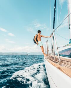A man enjoys sailing on the Aegean Sea, showcasing freedom and leisure on a sunny day.